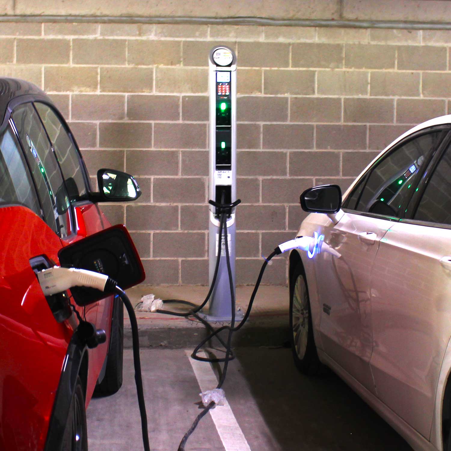 A new electric vehicle charger attached to two different cars.