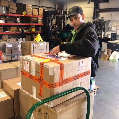 Mail staff sorting incoming packages for storage. Mail staff sorting incoming packages for storage.